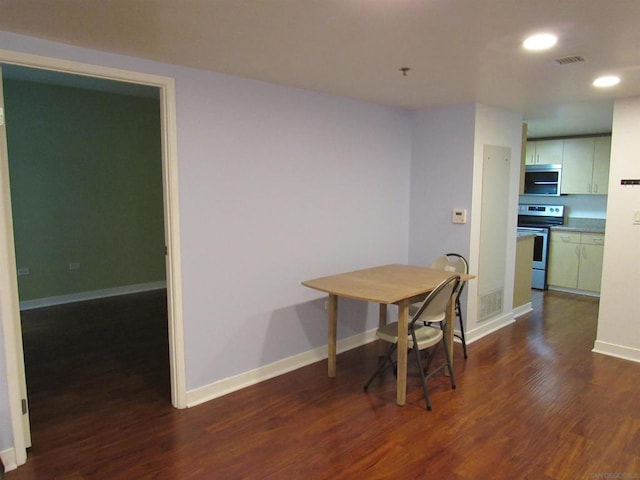 dining area with dark hardwood / wood-style floors