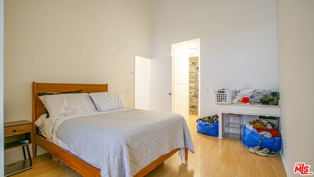 bedroom with hardwood / wood-style flooring and ensuite bath