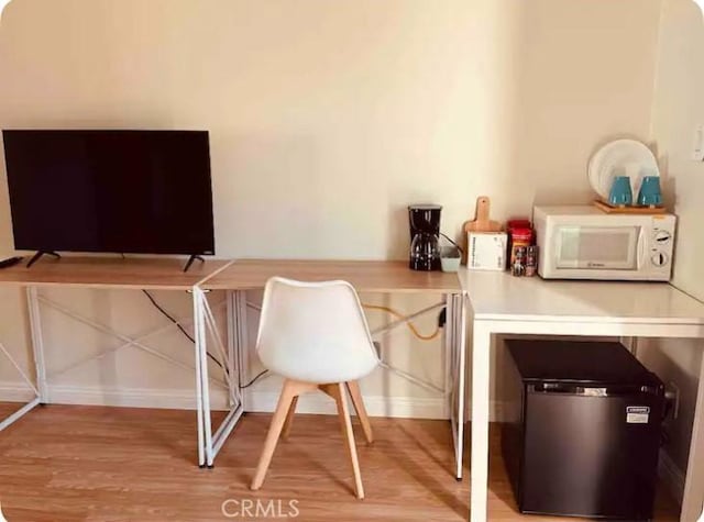 home office featuring light wood-style floors