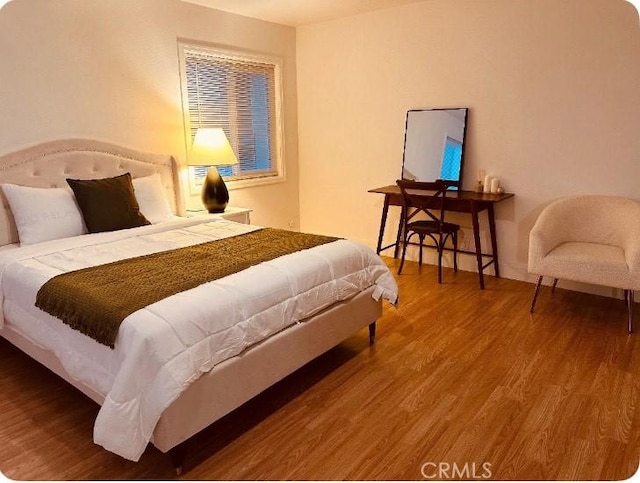 bedroom with wood finished floors