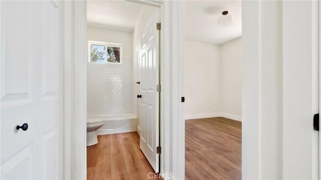 6241 Mountain View Dr, Paradise, CA 95969 - full bath featuring wood finished floors, a tub to relax in, toilet, and baseboards