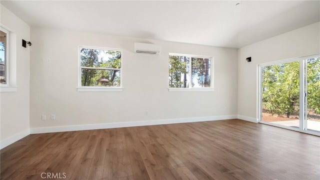 6241 Mountain View Dr, Paradise, CA 95969 - empty room featuring an AC wall unit, healthy amount of natural light, and wood finished floors