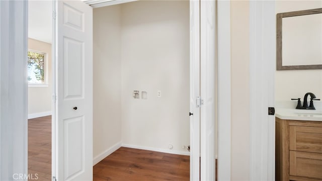 laundry area with dark hardwood / wood-style floors