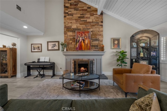 living room with vaulted ceiling with beams, a fireplace, and wood ceiling