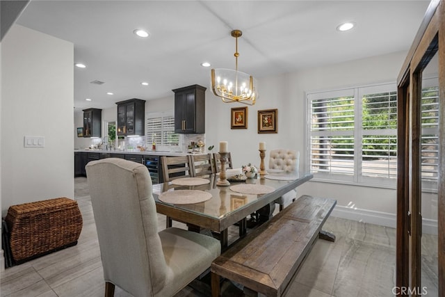 dining space featuring light hardwood / wood-style floors and an inviting chandelier