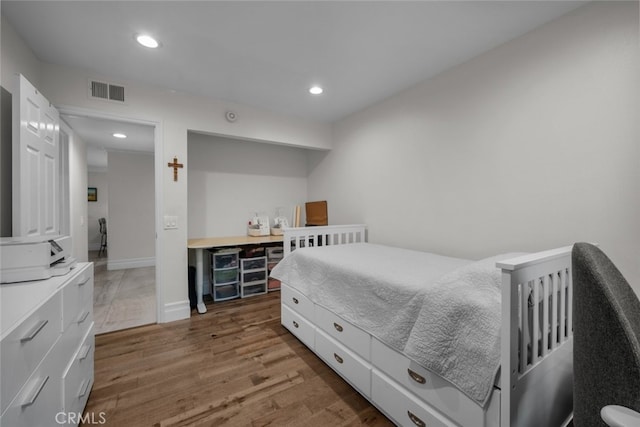 bedroom with hardwood / wood-style flooring