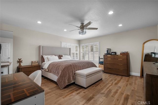 bedroom with light hardwood / wood-style floors and ceiling fan