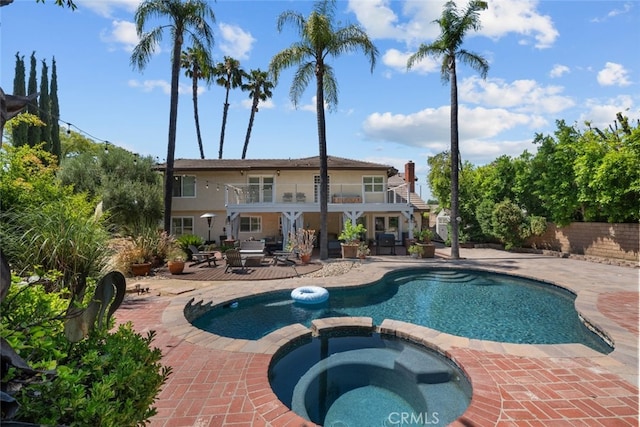 view of swimming pool featuring a patio and an in ground hot tub