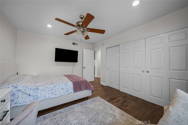 bedroom featuring a closet, dark wood-type flooring, and ceiling fan