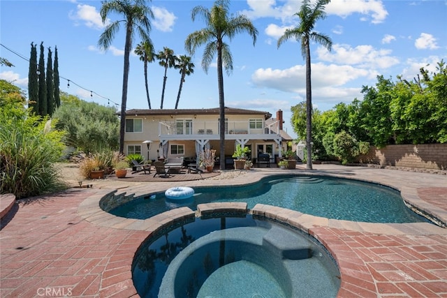 view of pool with an in ground hot tub and a patio