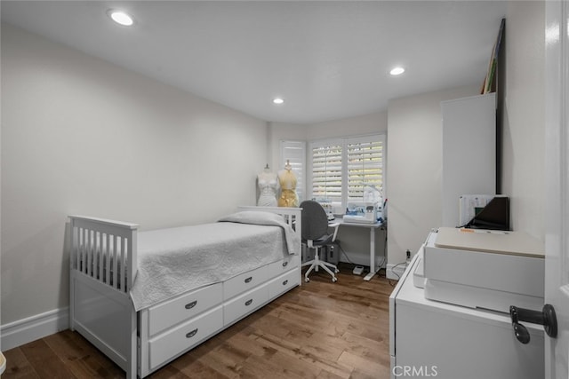 bedroom with hardwood / wood-style floors