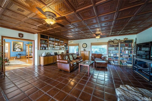 living area with dark tile patterned flooring, an ornate ceiling, and a ceiling fan