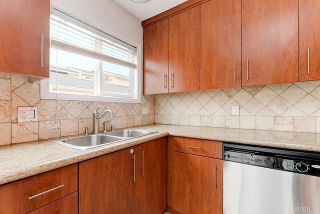 kitchen featuring tasteful backsplash, stainless steel dishwasher, and sink