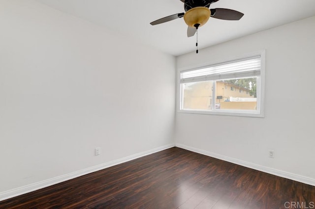 unfurnished room with ceiling fan and dark wood-type flooring