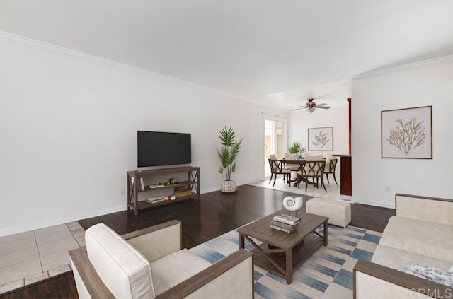 living room with wood-type flooring, ceiling fan, and crown molding