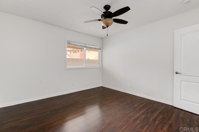 spare room with dark hardwood / wood-style floors and ceiling fan