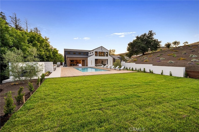 view of yard featuring a patio area, a fenced in pool, and a balcony