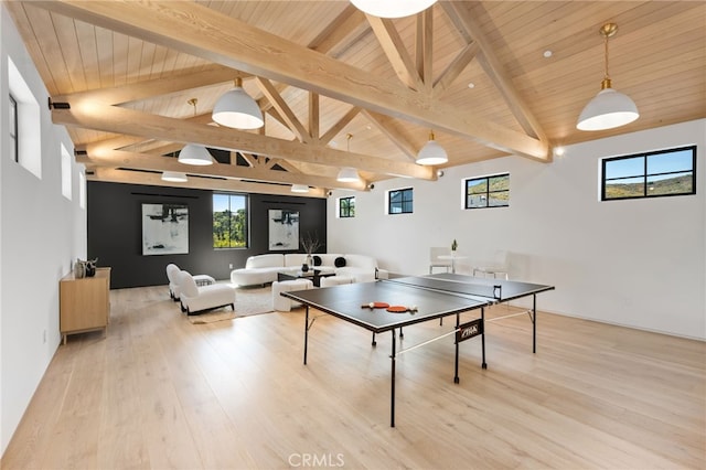 game room featuring vaulted ceiling with beams, light hardwood / wood-style flooring, and wood ceiling