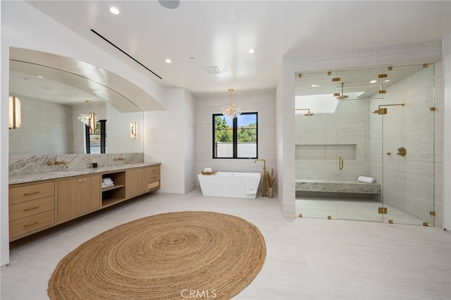 bathroom with vanity, an inviting chandelier, tile walls, tile patterned flooring, and shower with separate bathtub