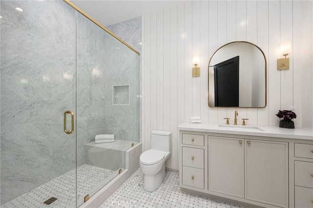 bathroom featuring vanity, wood walls, toilet, and a shower with door