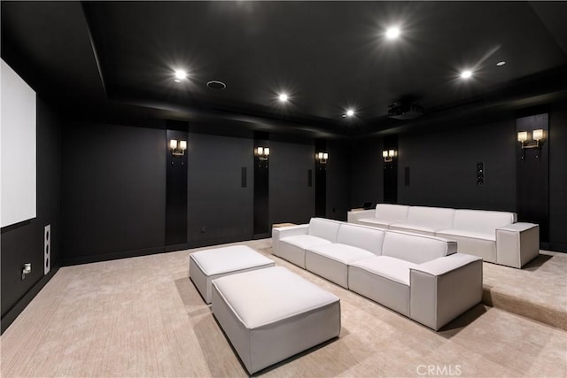 home theater room with light colored carpet