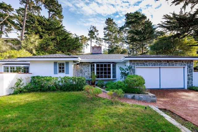 single story home with a front yard and a garage