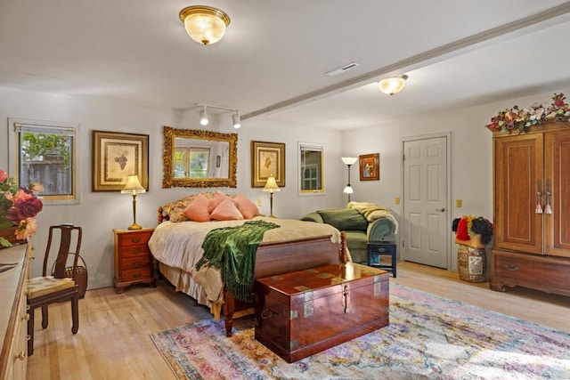 bedroom with light wood-type flooring and rail lighting