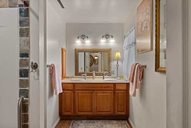 bathroom with hardwood / wood-style floors and vanity