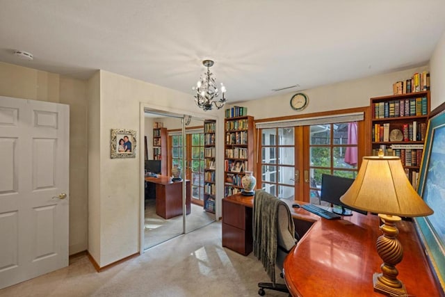 home office with a chandelier, light colored carpet, and french doors