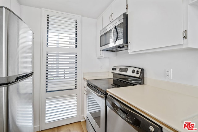 kitchen featuring light hardwood / wood-style floors, white cabinetry, and stainless steel appliances