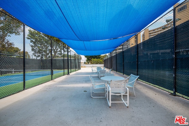 view of patio / terrace featuring tennis court