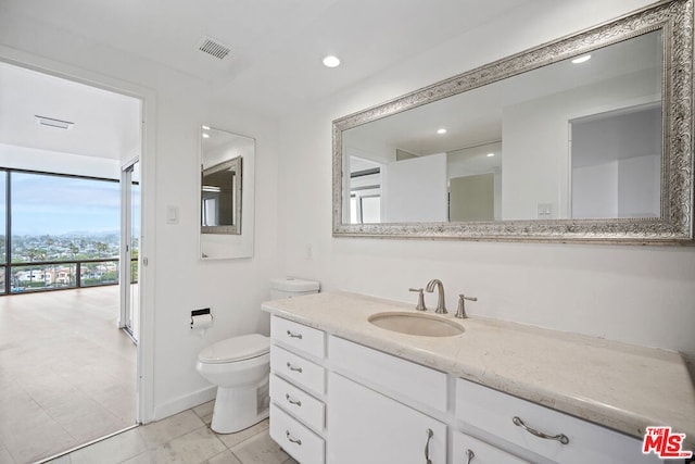 bathroom with vanity and toilet