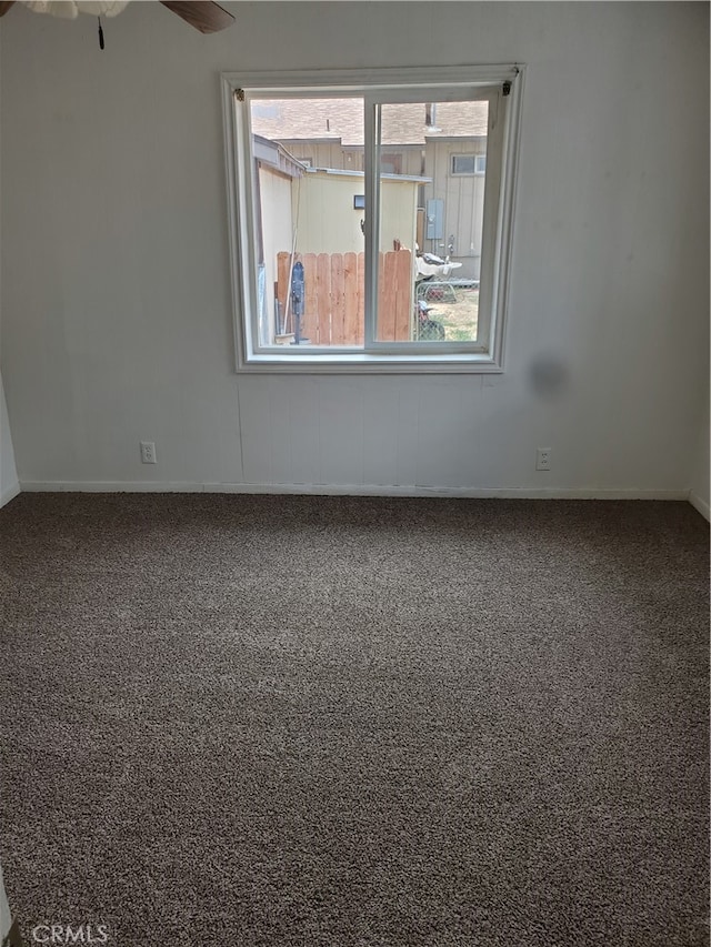 spare room featuring ceiling fan, carpet floors, and plenty of natural light