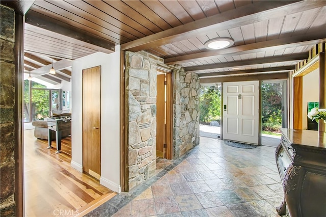 foyer entrance with hardwood / wood-style flooring, beamed ceiling, and wooden ceiling