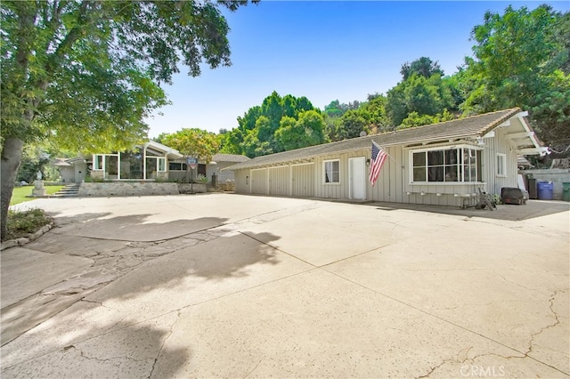 view of front of house with a sunroom and a patio