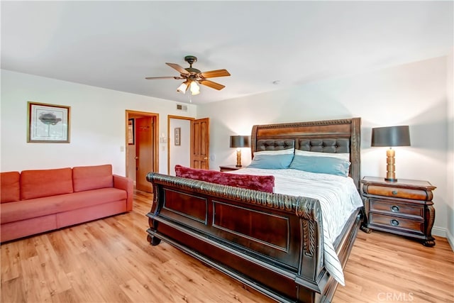 bedroom with light hardwood / wood-style floors and ceiling fan