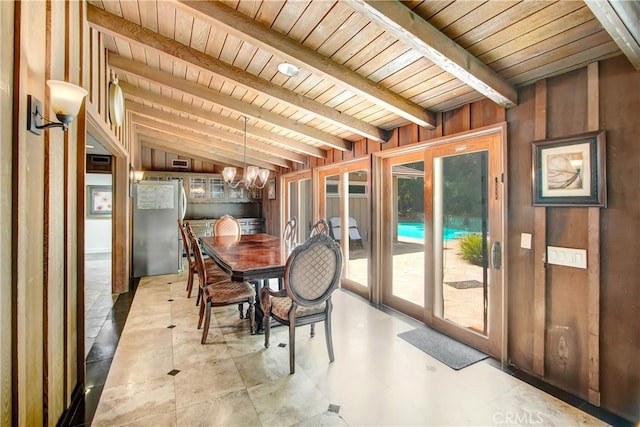 sunroom / solarium featuring wooden ceiling, vaulted ceiling with beams, and a notable chandelier