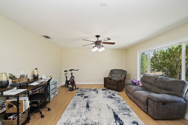 office with ceiling fan and light hardwood / wood-style flooring