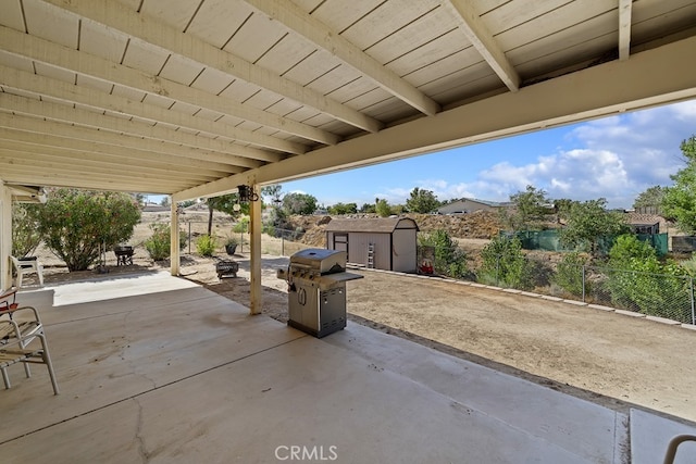 view of patio featuring a grill and a storage shed