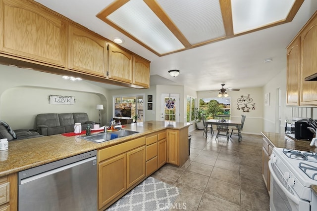 kitchen featuring dishwasher, ceiling fan, white gas stove, light tile patterned floors, and sink