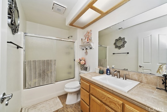 full bathroom with toilet, bath / shower combo with glass door, and vanity