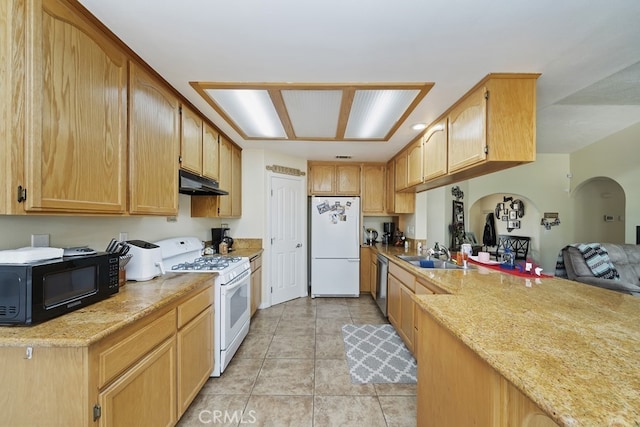 kitchen featuring sink, white appliances, light stone countertops, and light tile patterned floors