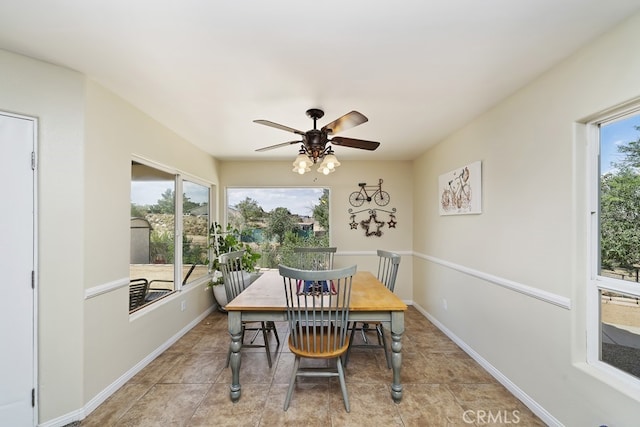 dining space with light tile patterned flooring and ceiling fan