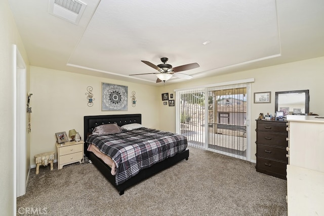 bedroom featuring a raised ceiling, ceiling fan, access to outside, and carpet