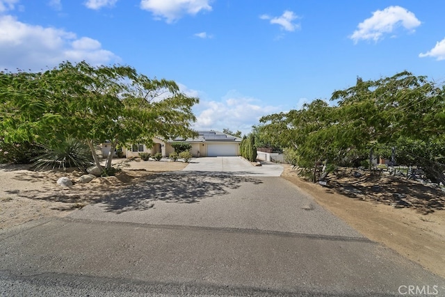 view of front of house featuring solar panels and a garage