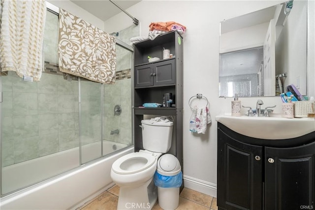 full bathroom featuring vanity, bath / shower combo with glass door, toilet, and tile patterned flooring