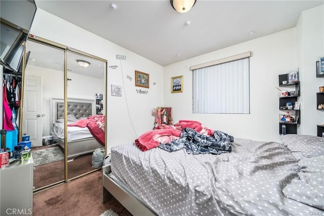 bedroom featuring a closet and dark colored carpet