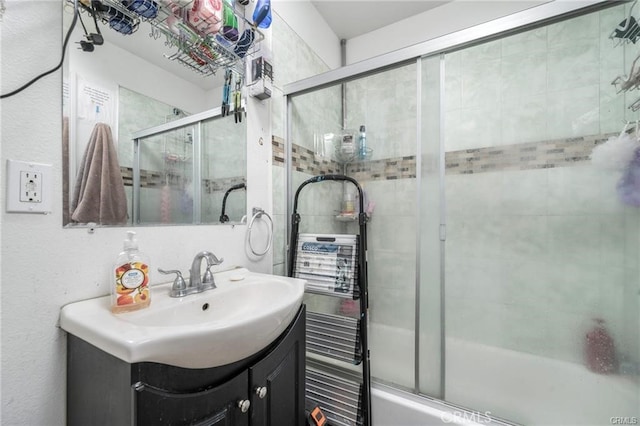 bathroom featuring vanity and enclosed tub / shower combo