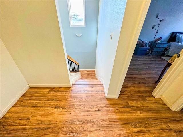 corridor with wood-type flooring