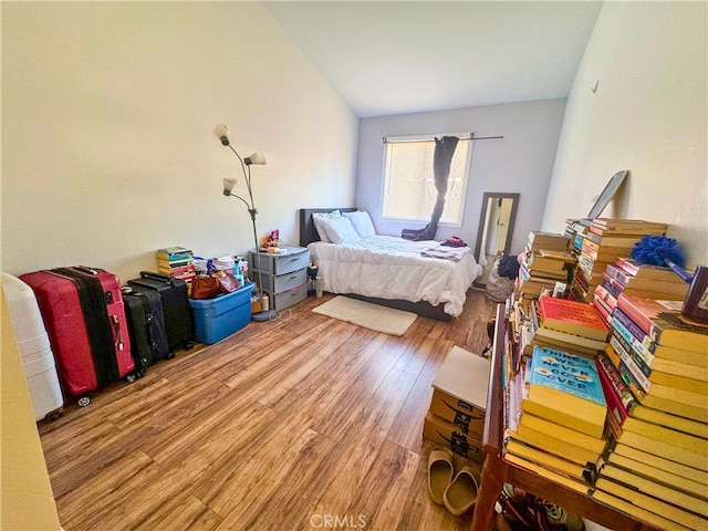 bedroom featuring lofted ceiling and wood-type flooring